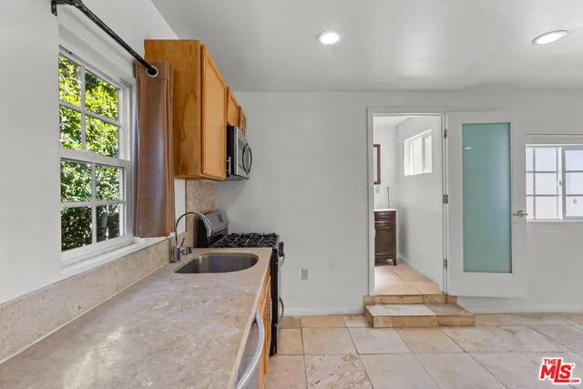 a bathroom with a tub sink and window