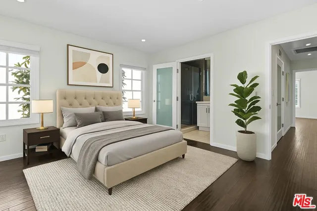 a bedroom with a bed and a potted plant
