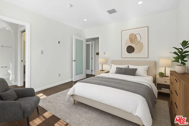 a spacious bedroom with a bed and a couch