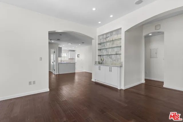 a view of a kitchen with wooden floor and a sink