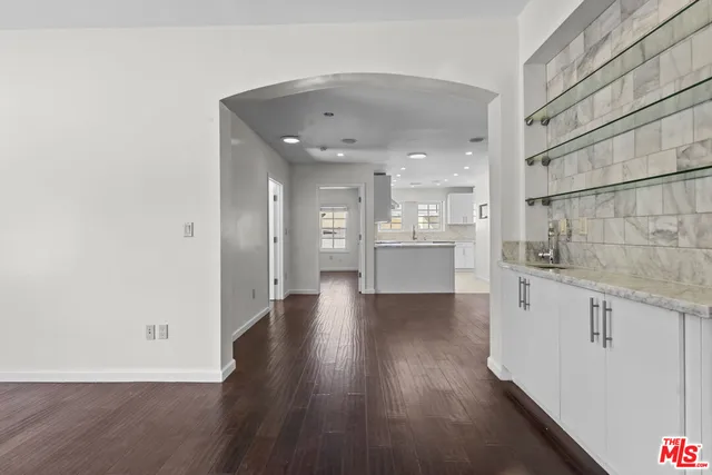 a view of a kitchen with wooden floor and a sink