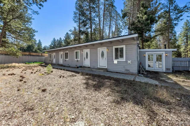 a view of a house with yard and sitting area
