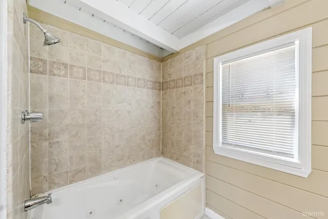 a bathroom with a bathtub and shower