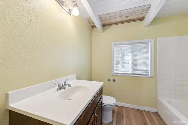 a bathroom with a sink a toilet and vanity