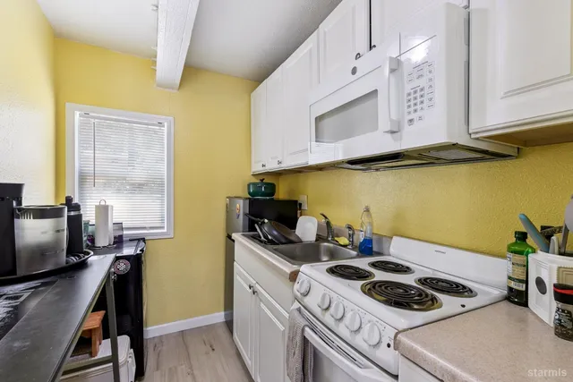 a kitchen with stainless steel appliances a stove a sink and a refrigerator