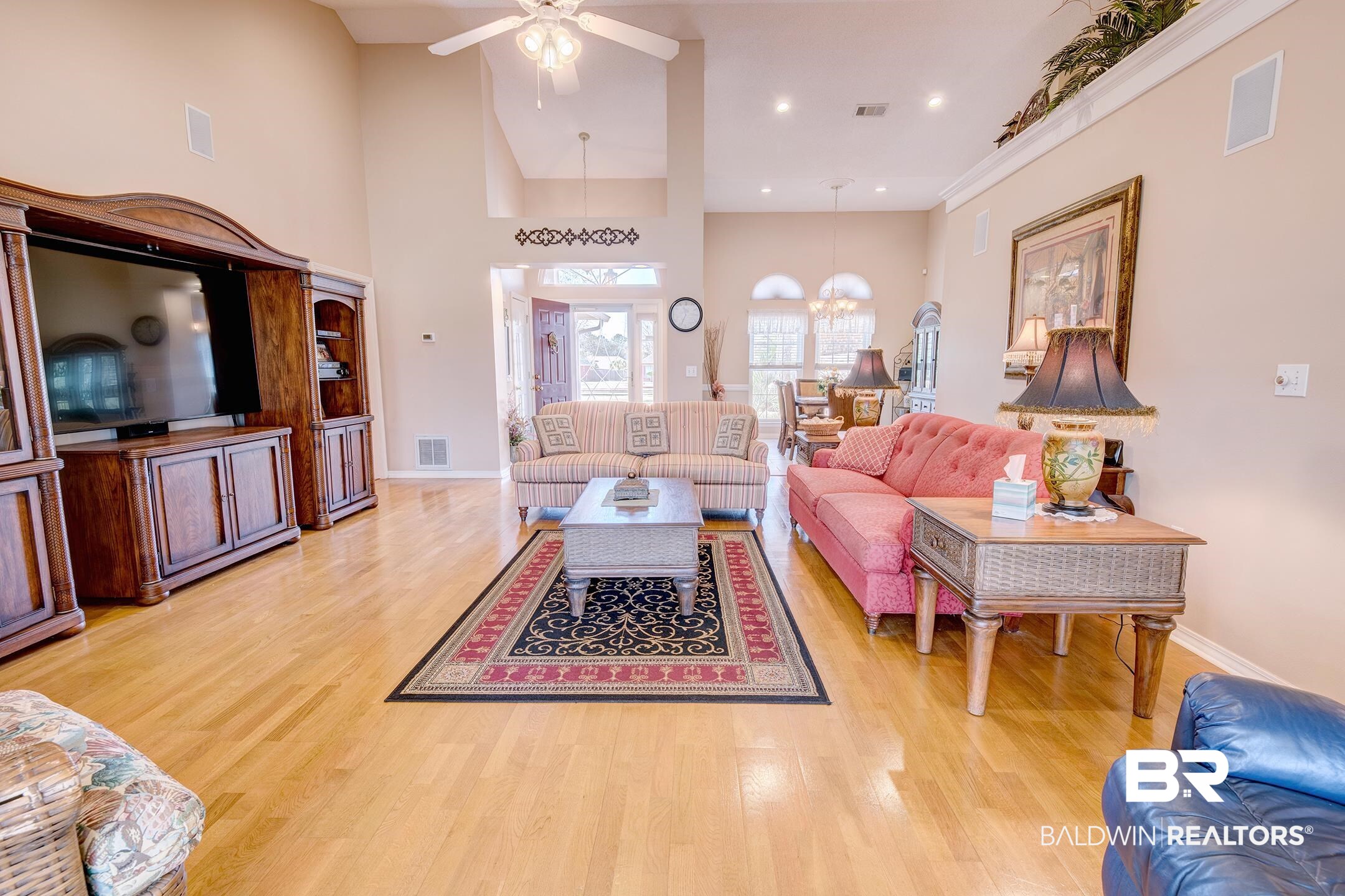 12626 Hunters Chase Foley, AL 36535 - Photo 10 of 40 Living area with ceiling fan, a high ceiling, light wood-style flooring, and suspended lighting