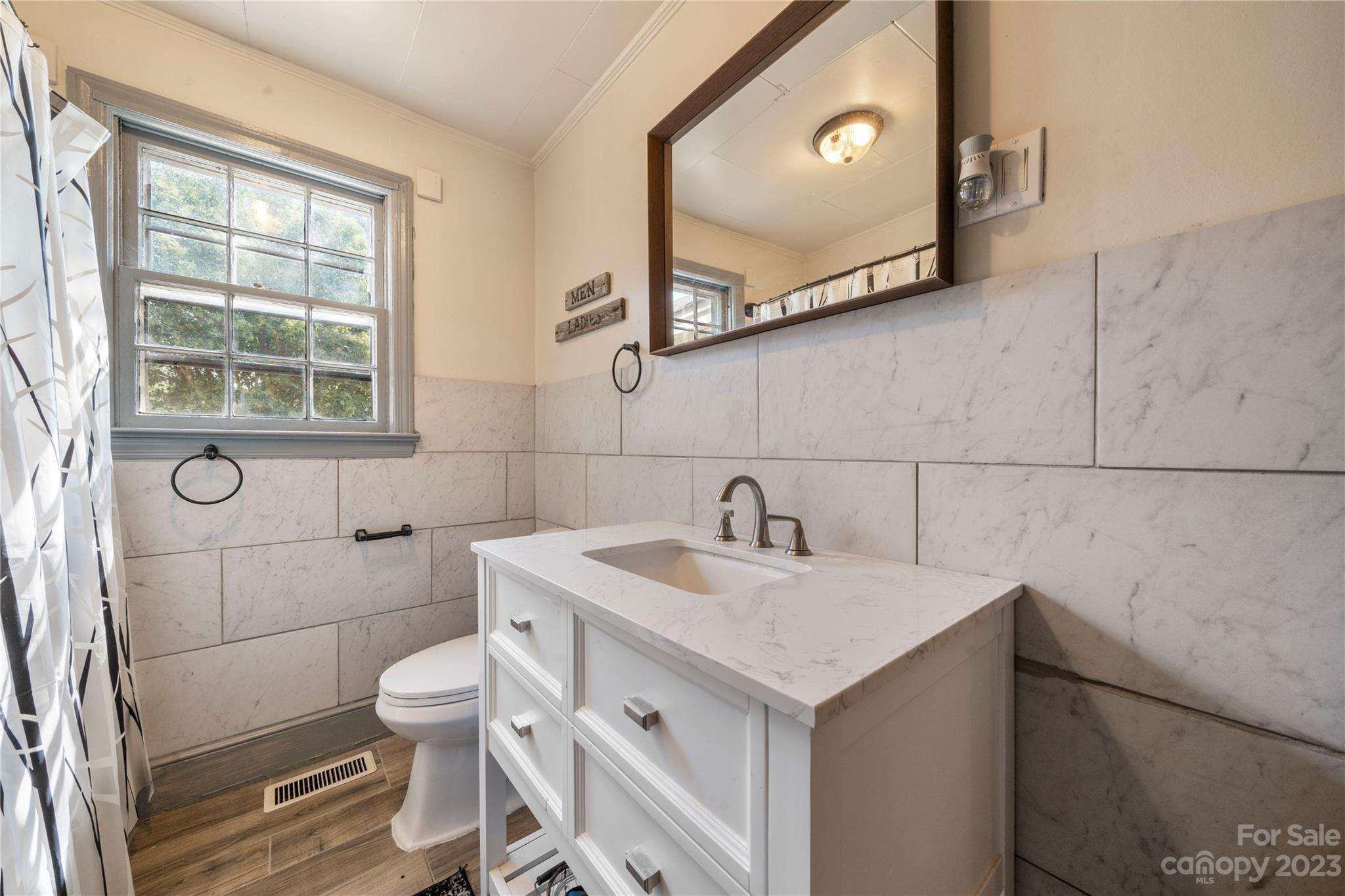 818 Old Buncombe Road Union, SC 29379 - Photo 13 of 27 a bathroom with a sink vanity and toilet