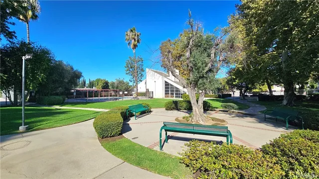 a swimming pool with an outdoor space and seating area
