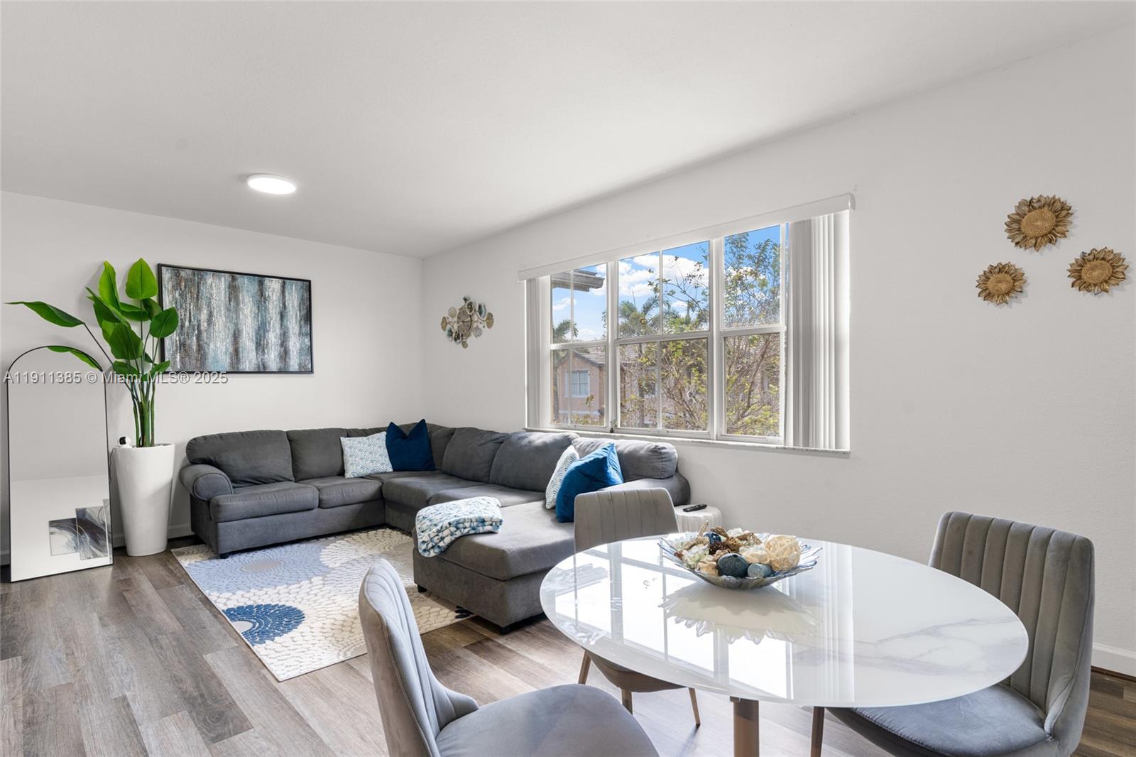 230 Southeast 29th Avenue, Unit 21 Homestead, FL 33033 - Photo 12 of 34 a living room with furniture and a large window