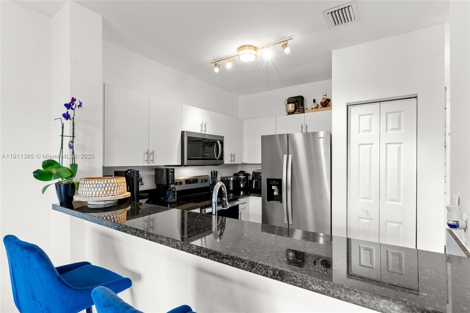 230 Southeast 29th Avenue, Unit 21 Homestead, FL 33033 - Photo 14 of 34 a kitchen with stainless steel appliances granite countertop a refrigerator a stove and a sink