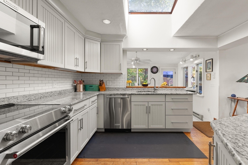 109 Riverview Road Gloucester, MA 01930 - Photo 12 of 42 a kitchen with granite countertop a sink stainless steel appliances and cabinets