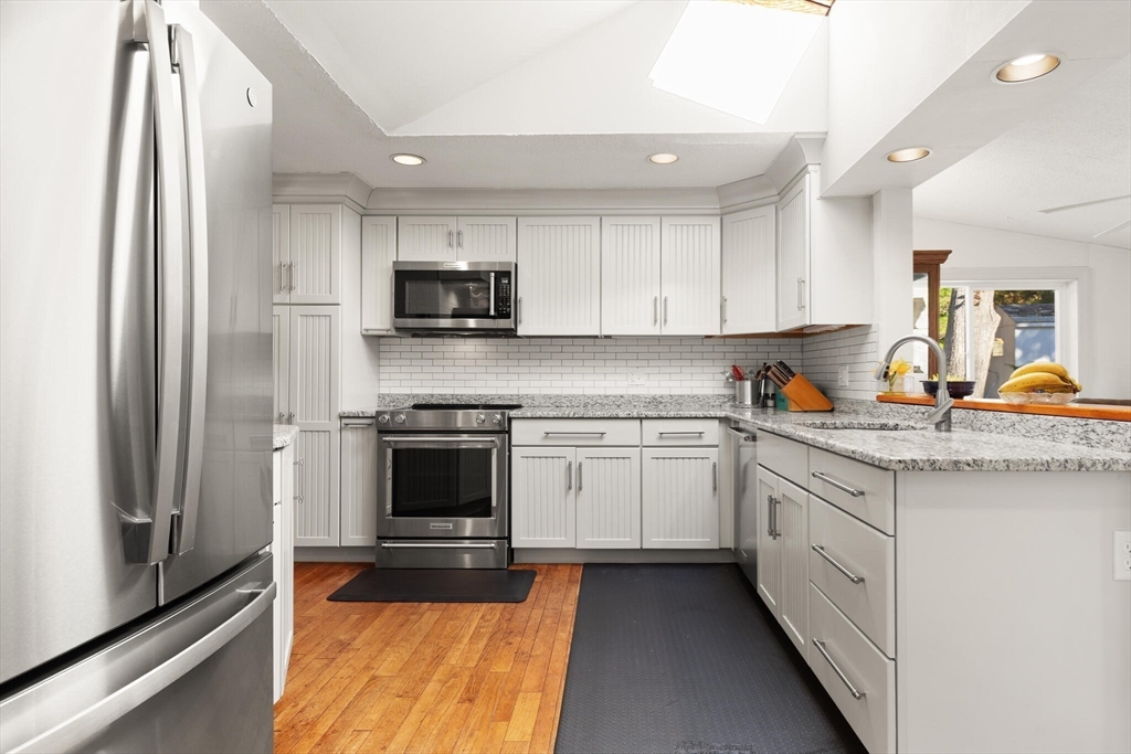 109 Riverview Road Gloucester, MA 01930 - Photo 13 of 42 a kitchen with stainless steel appliances granite countertop a refrigerator sink and stove