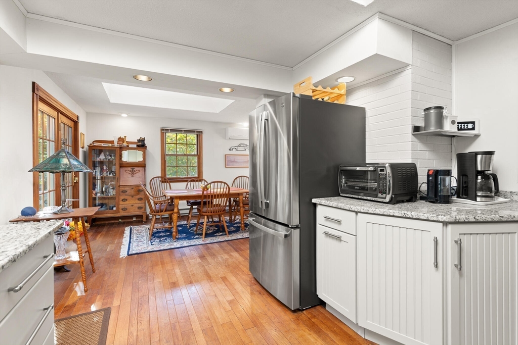 109 Riverview Road Gloucester, MA 01930 - Photo 14 of 42 a kitchen with stainless steel appliances granite countertop a refrigerator a stove and a wooden floors