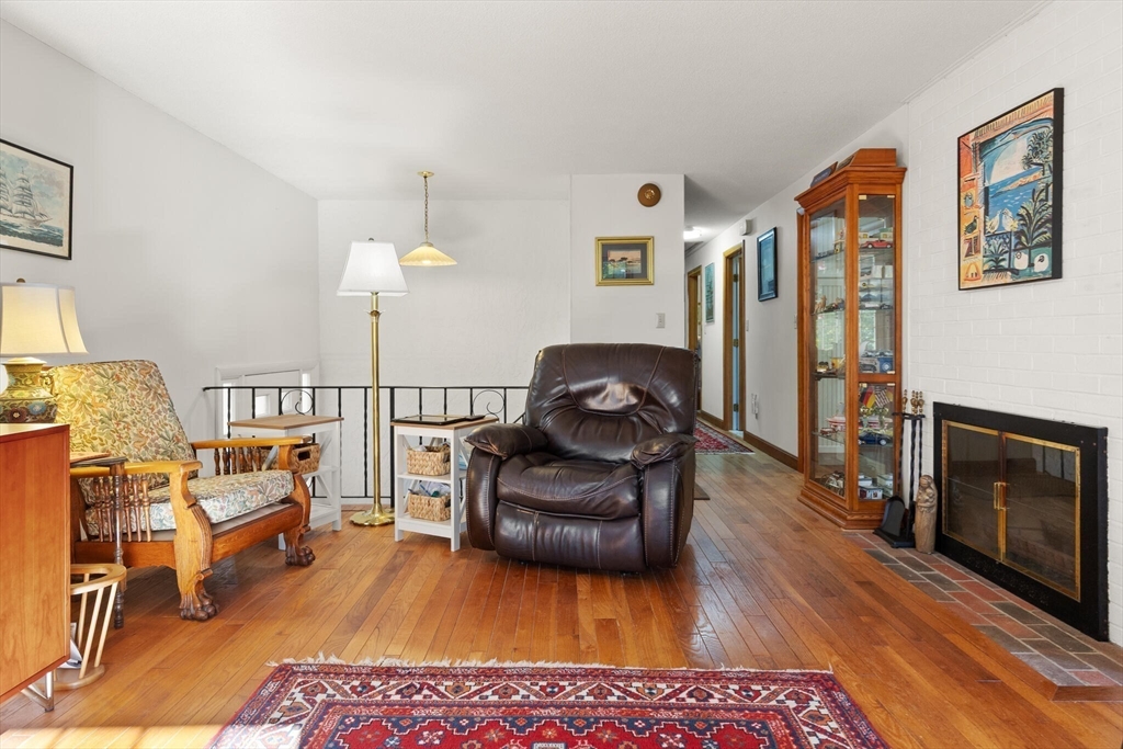 109 Riverview Road Gloucester, MA 01930 - Photo 7 of 42 a living room with furniture a fireplace and a flat screen tv