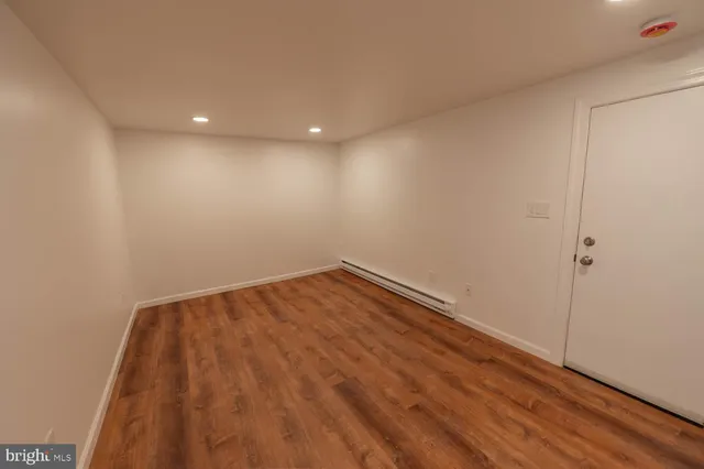a view of room with wooden floor and fan