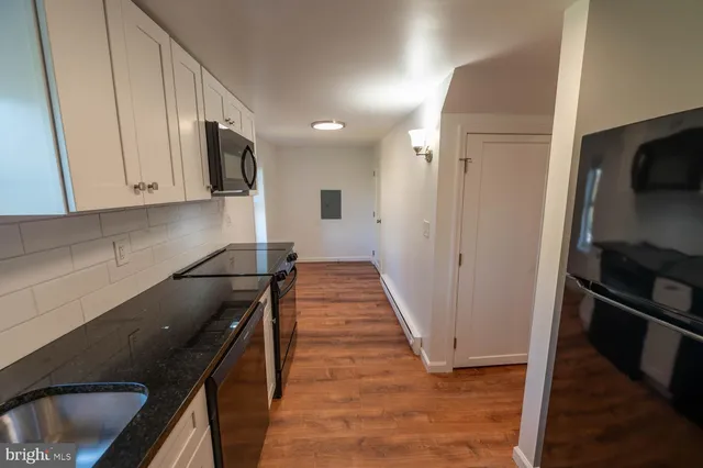a view of a kitchen from the hallway