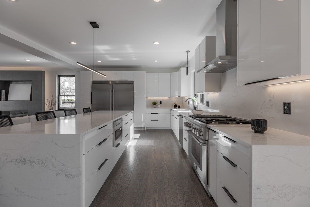 46 Beverly Road Arlington, MA 02474 - Photo 18 of 42 a large kitchen with stainless steel appliances granite countertop a lot of counter space and wooden floors