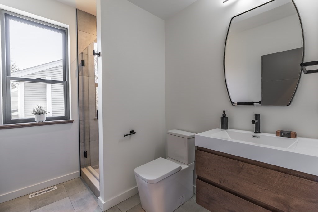 46 Beverly Road Arlington, MA 02474 - Photo 21 of 42 a bathroom with a toilet sink and mirror