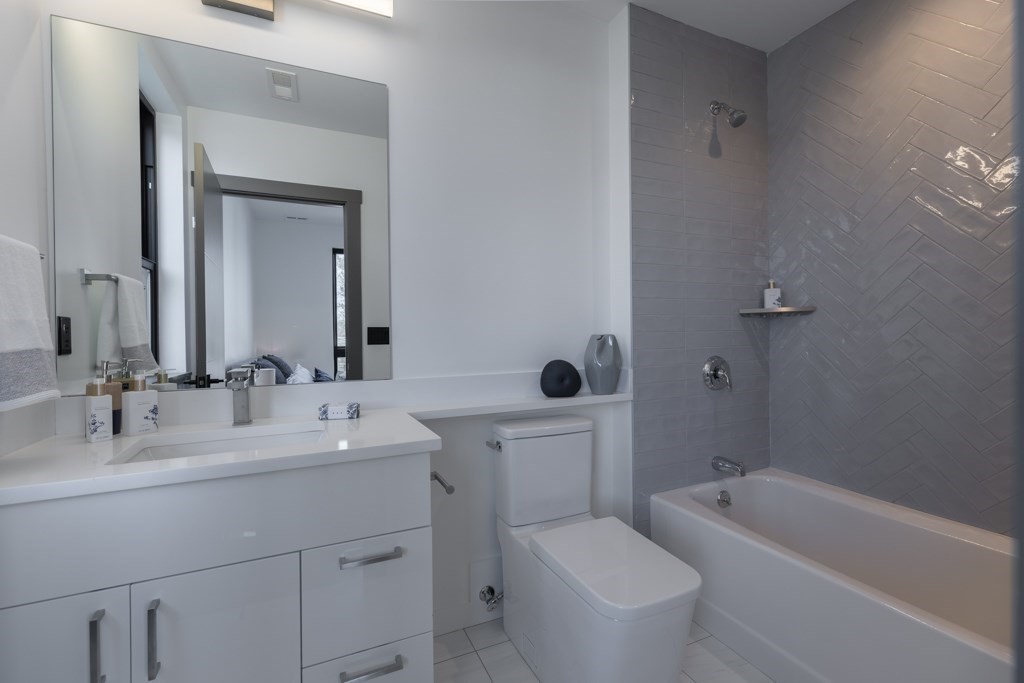 46 Beverly Road Arlington, MA 02474 - Photo 32 of 42 a bathroom with a bathtub shower sink mirror and toilet