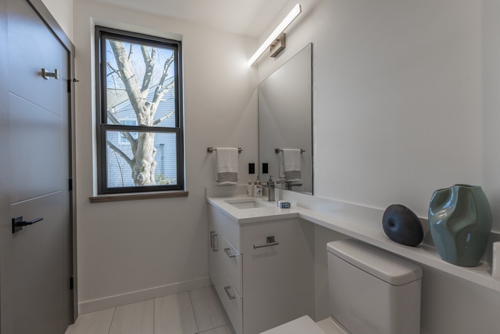 46 Beverly Road Arlington, MA 02474 - Photo 33 of 42 a bathroom with a sink a toilet and a mirror