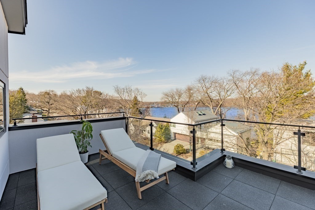 46 Beverly Road Arlington, MA 02474 - Photo 4 of 42 a view of a chairs and table in the balcony