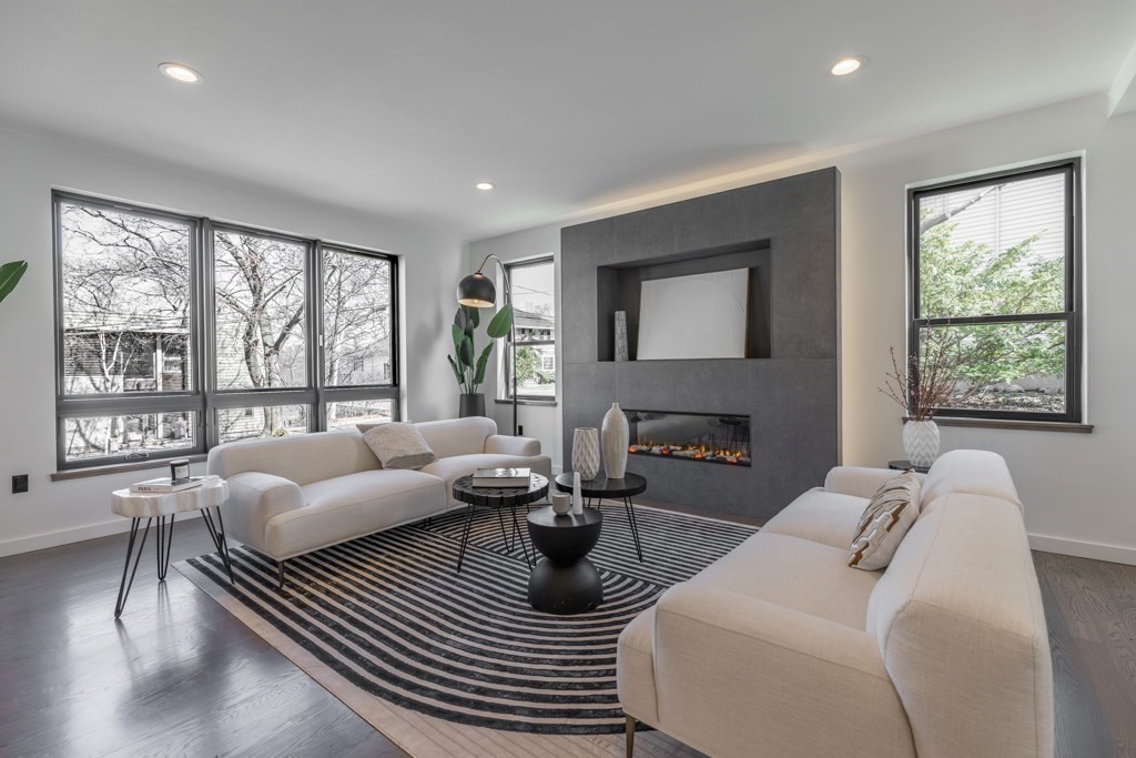 46 Beverly Road Arlington, MA 02474 - Photo 9 of 42 a living room with furniture a large window and a wooden floor