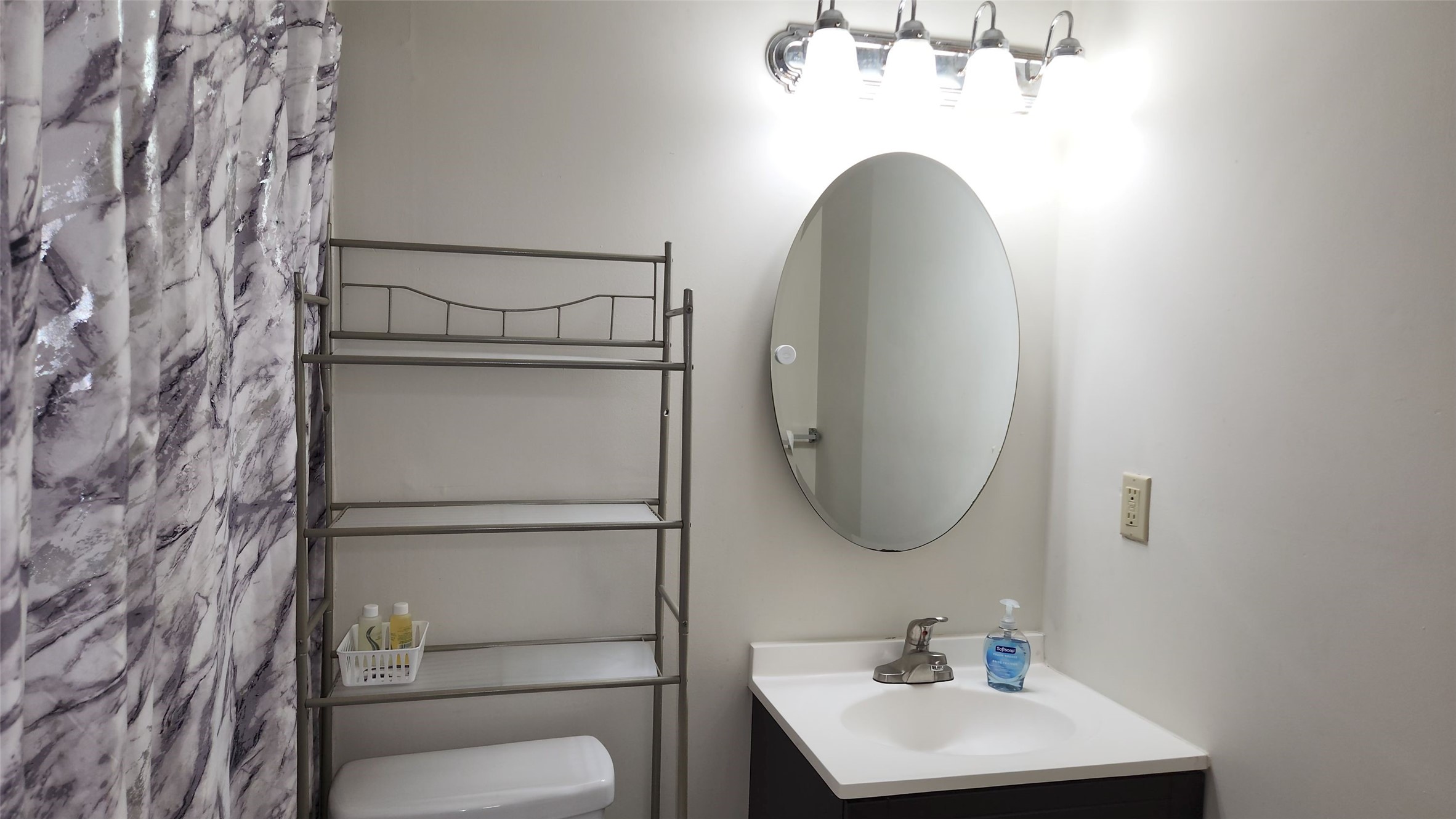 4727 West Alabama Street, Unit 104 Houston, TX 77027 - Photo 5 of 10 a bathroom with a toilet sink and mirror