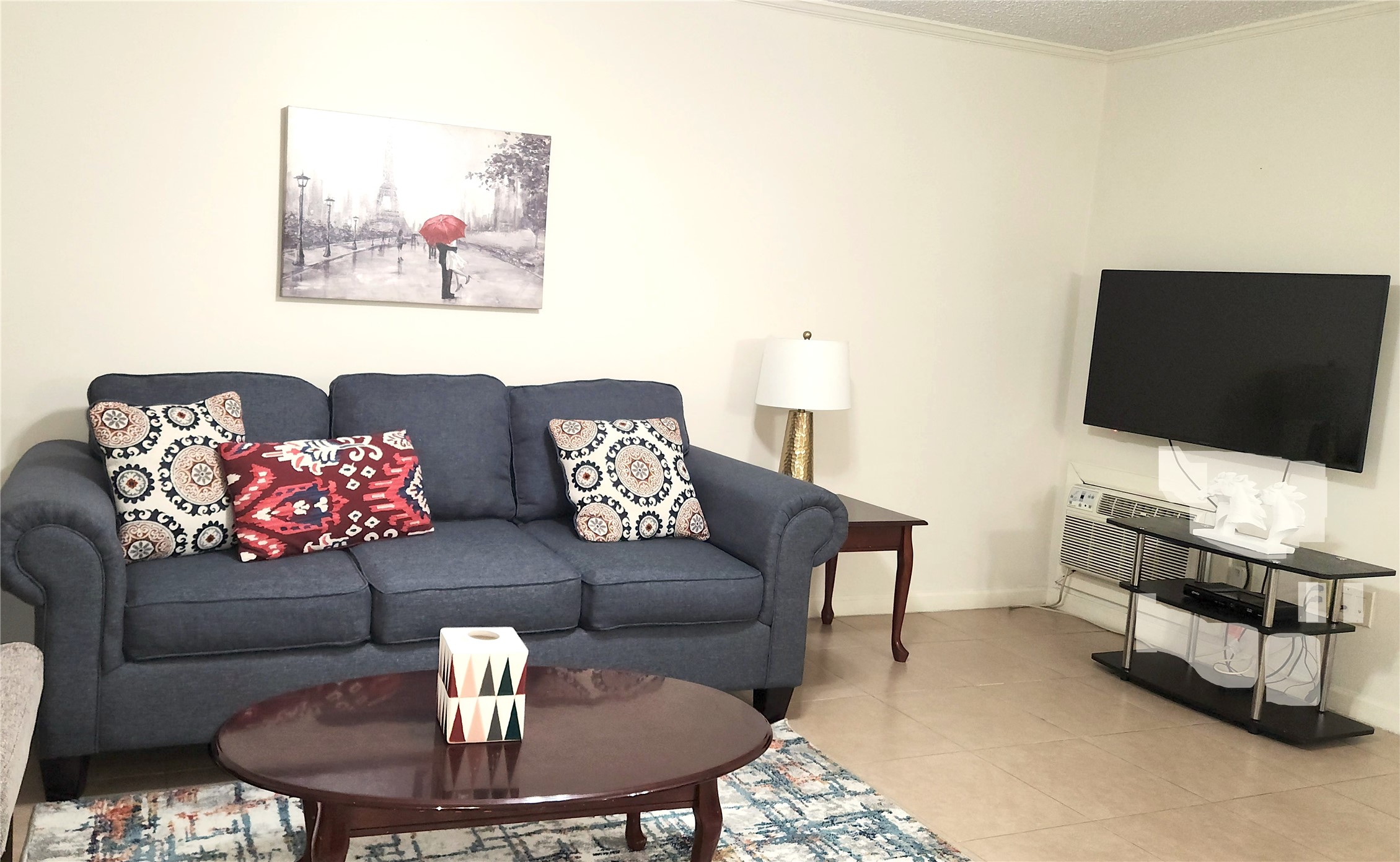 4727 West Alabama Street, Unit 104 Houston, TX 77027 - Photo 7 of 10 a living room with furniture and a flat screen tv