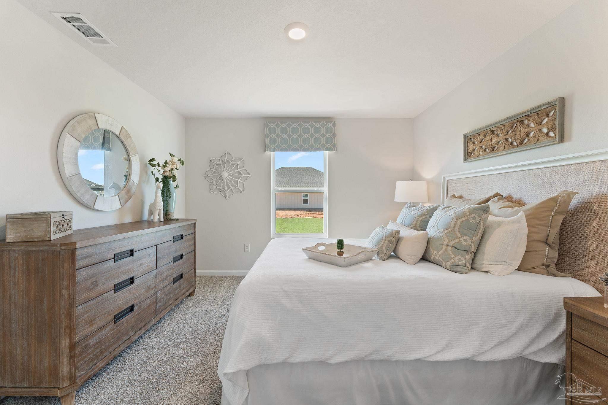 4884 Canvasback Boulevard Pace, FL 32571 - Photo 9 of 22 a bedroom with a bed and a dresser