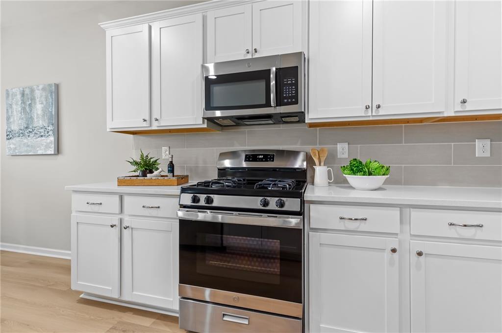 325 Winston Circle Canton, GA 30114 - Photo 13 of 38 a kitchen with white cabinets and appliances
