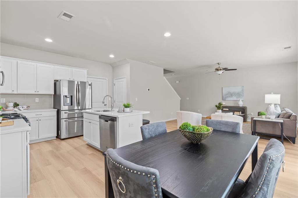 325 Winston Circle Canton, GA 30114 - Photo 18 of 38 a living room with stainless steel appliances furniture a dining table and kitchen view