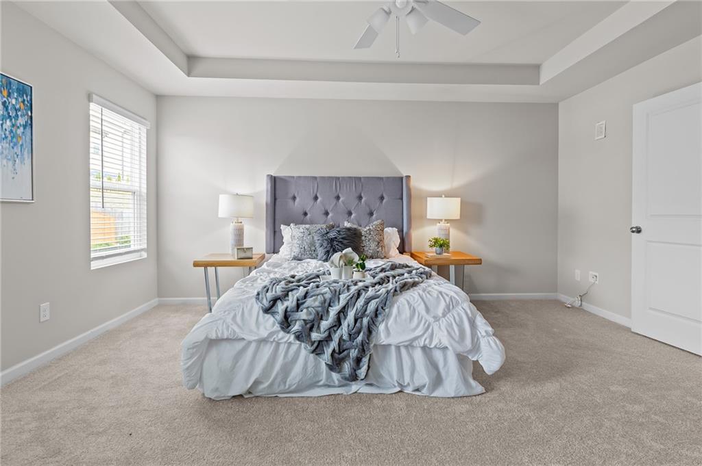 325 Winston Circle Canton, GA 30114 - Photo 22 of 38 a bed sitting in a bedroom next to a window and a larger closet