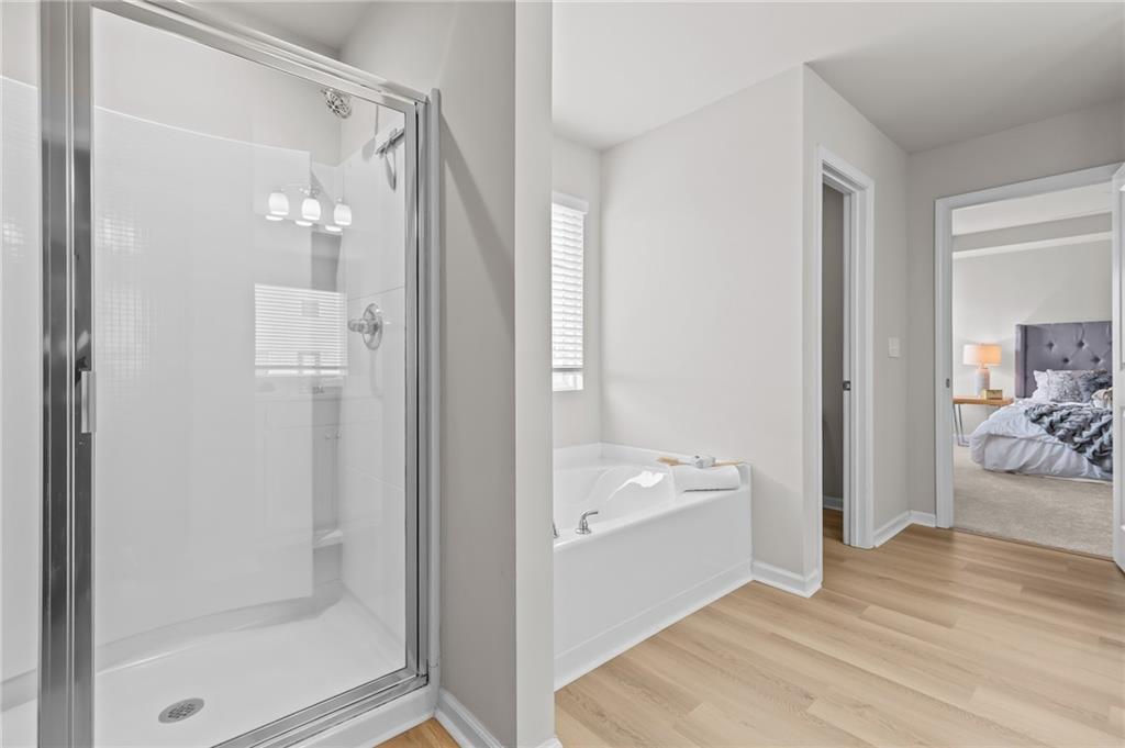 325 Winston Circle Canton, GA 30114 - Photo 25 of 38 a bathroom with a tub shower and sink