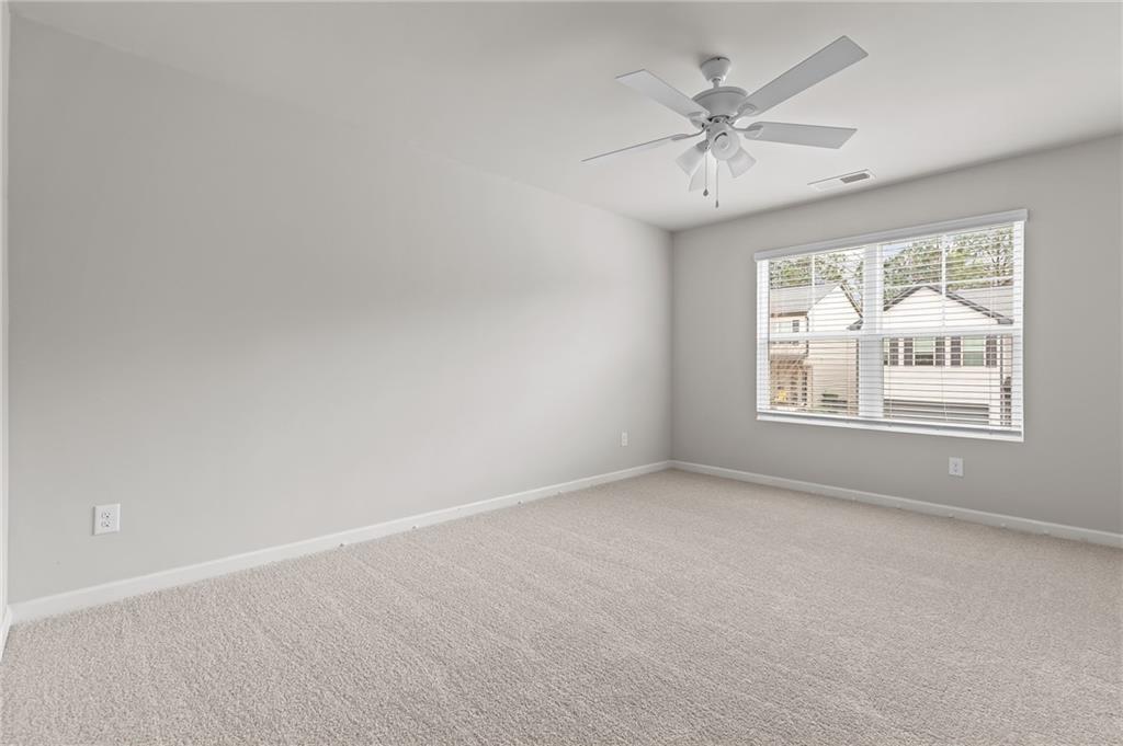 325 Winston Circle Canton, GA 30114 - Photo 26 of 38 an empty room with a window and a ceiling fan
