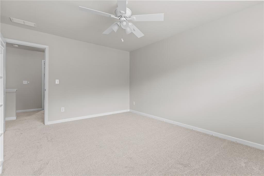 325 Winston Circle Canton, GA 30114 - Photo 27 of 38 an empty room with a ceiling fan and a window