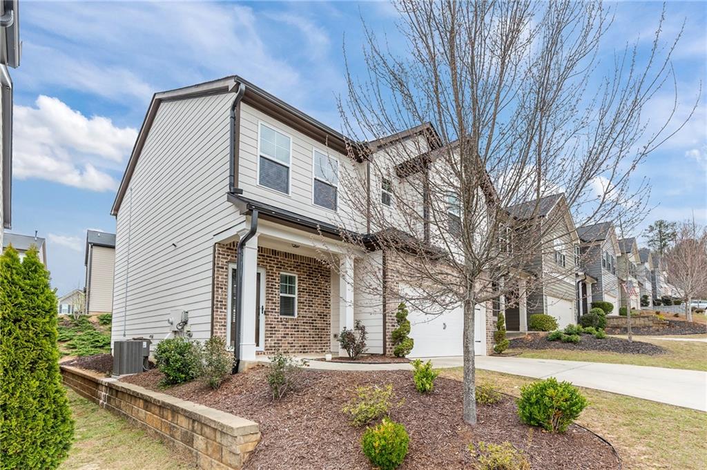 325 Winston Circle Canton, GA 30114 - Photo 3 of 38 a front view of a house with a yard and potted plants