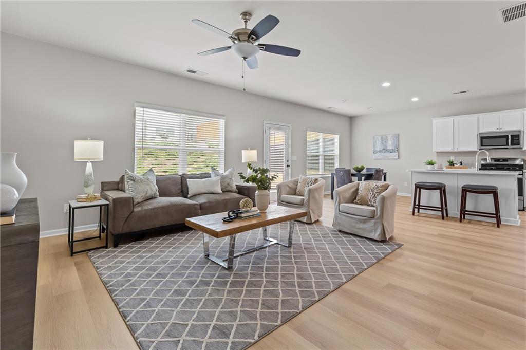 325 Winston Circle Canton, GA 30114 - Photo 6 of 38 a living room with furniture and a wooden floor
