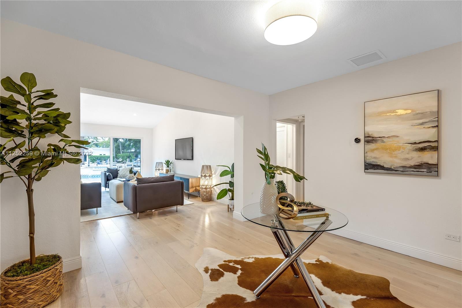 1757 Daytonia Road Miami Beach, FL 33141 - Photo 14 of 30 a living room with furniture and a potted plant