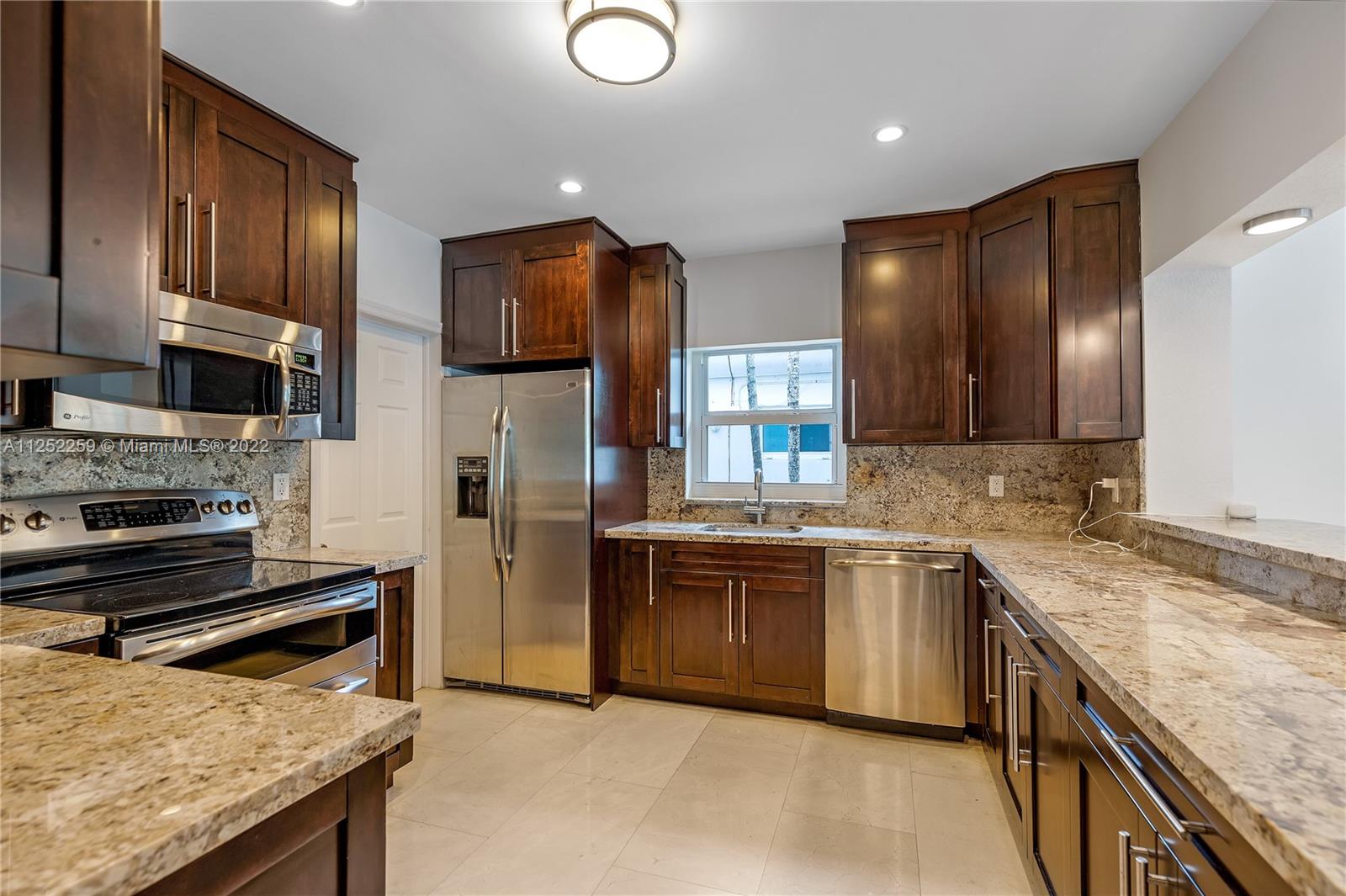 1757 Daytonia Road Miami Beach, FL 33141 - Photo 15 of 30 a kitchen with stainless steel appliances granite countertop refrigerator sink and stove