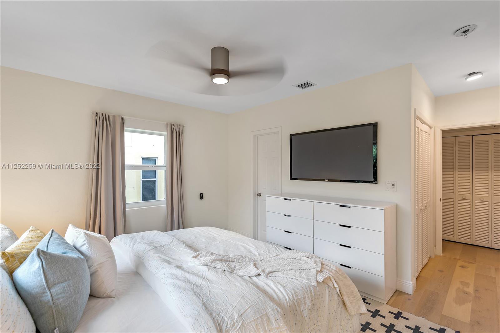 1757 Daytonia Road Miami Beach, FL 33141 - Photo 21 of 30 a bedroom with a bed and a flat screen tv