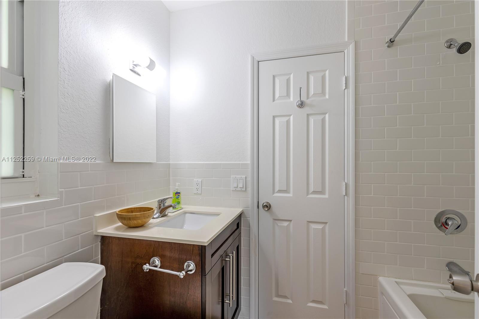 1757 Daytonia Road Miami Beach, FL 33141 - Photo 22 of 30 a bathroom with a sink a toilet and shower