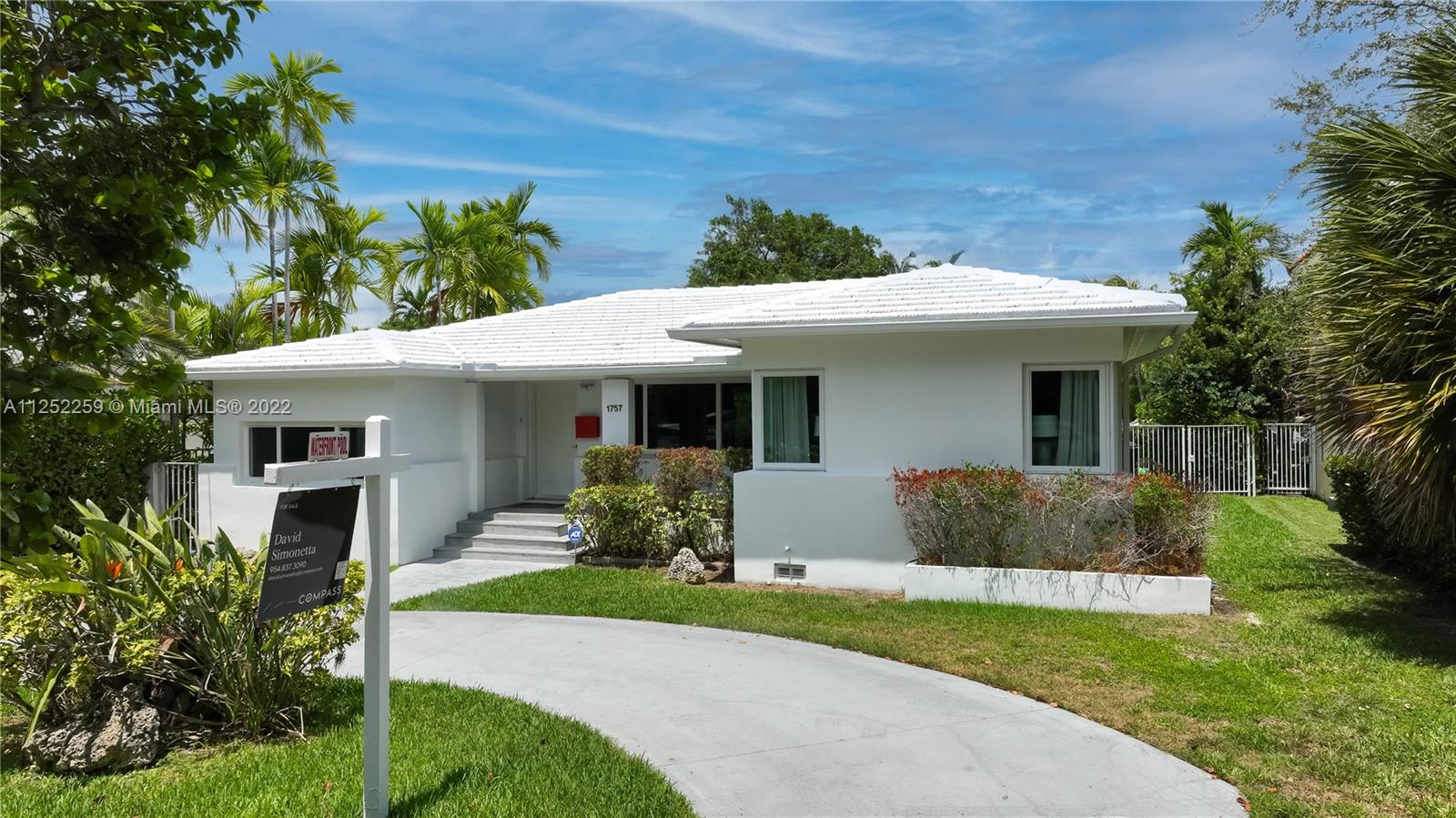 1757 Daytonia Road Miami Beach, FL 33141 - Photo 24 of 30 a front view of a house with a yard and porch