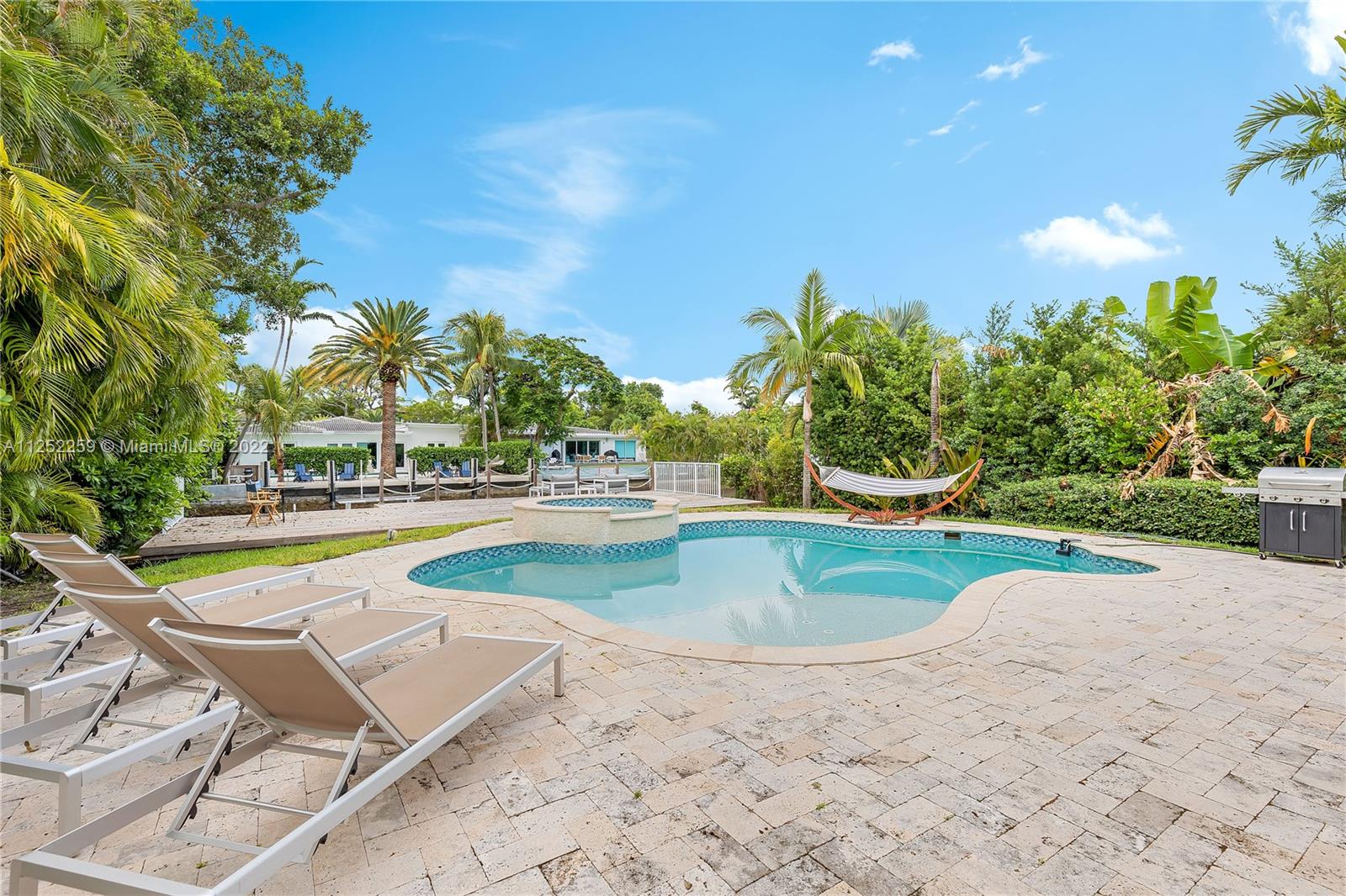 1757 Daytonia Road Miami Beach, FL 33141 - Photo 4 of 30 a view of a swimming pool with an outdoor space and seating area