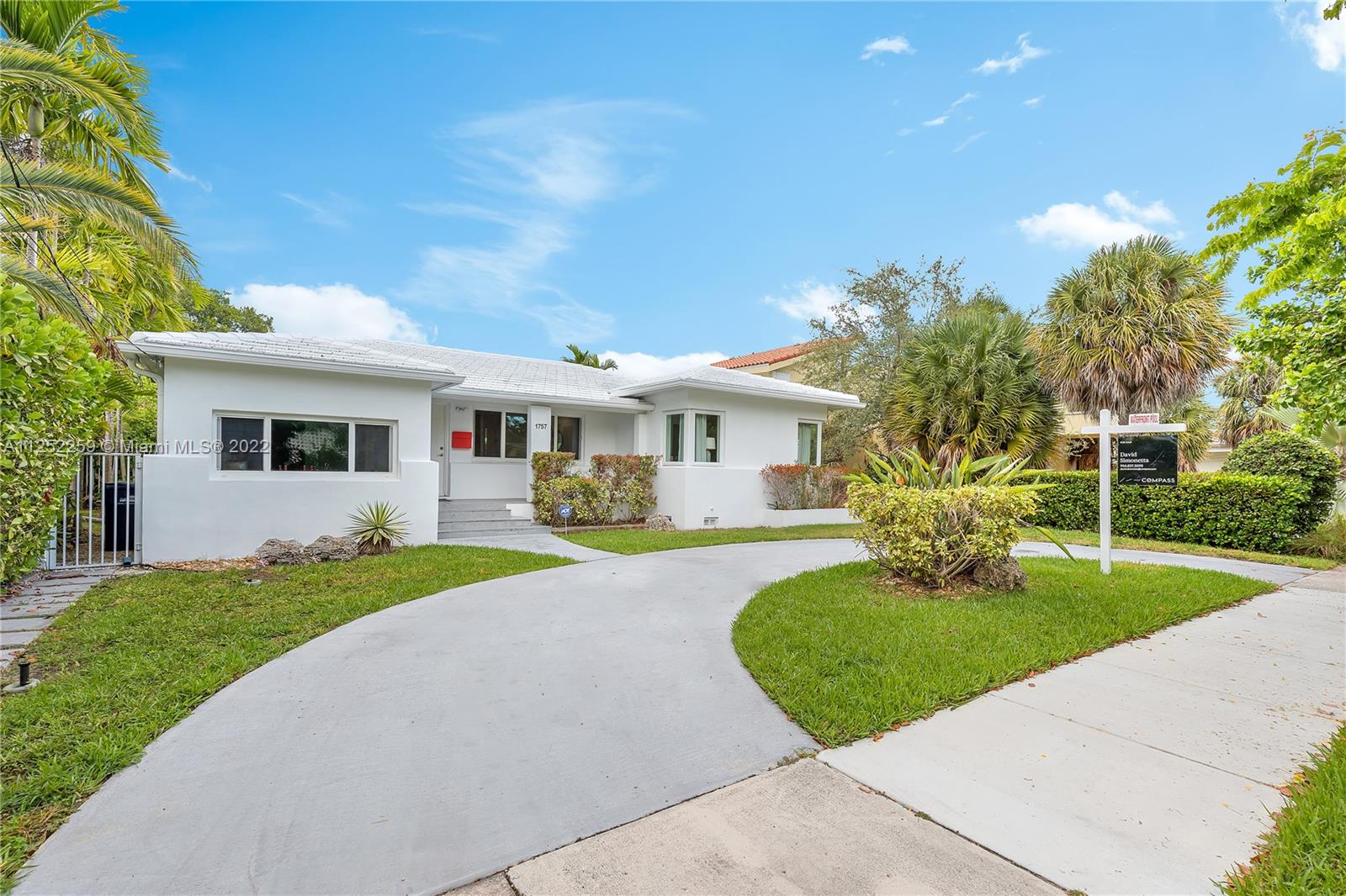 1757 Daytonia Road Miami Beach, FL 33141 - Photo 5 of 30 a front view of a house with a yard and porch