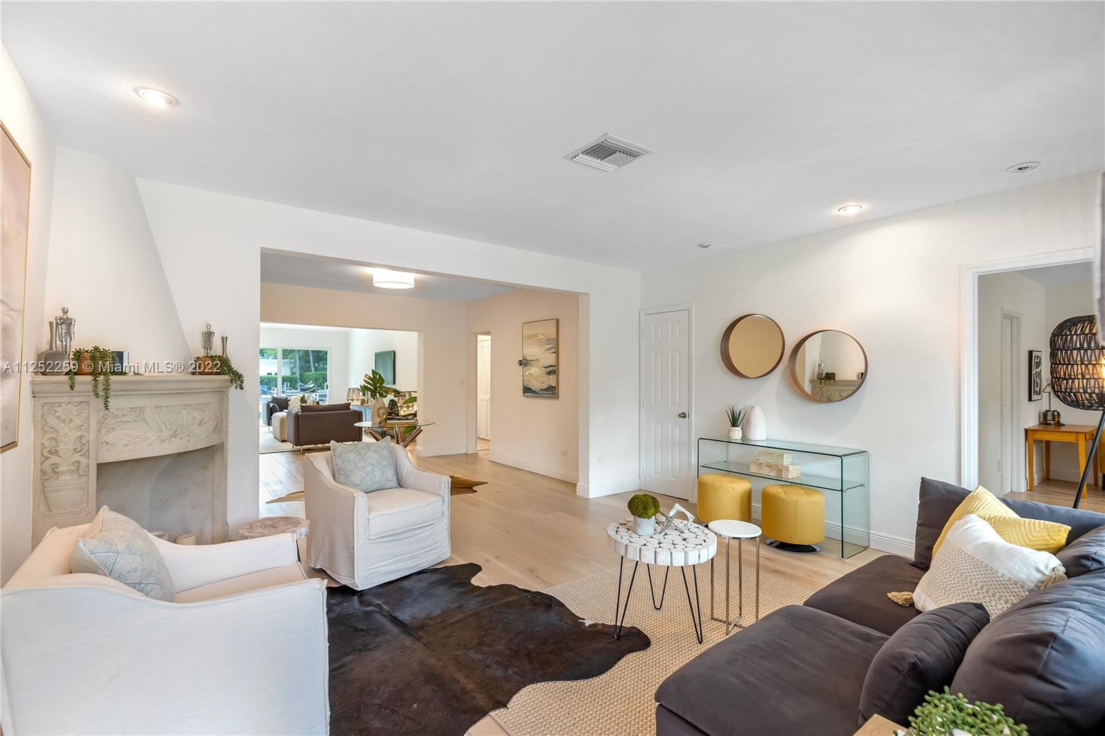 1757 Daytonia Road Miami Beach, FL 33141 - Photo 9 of 30 a living room with furniture and a fireplace