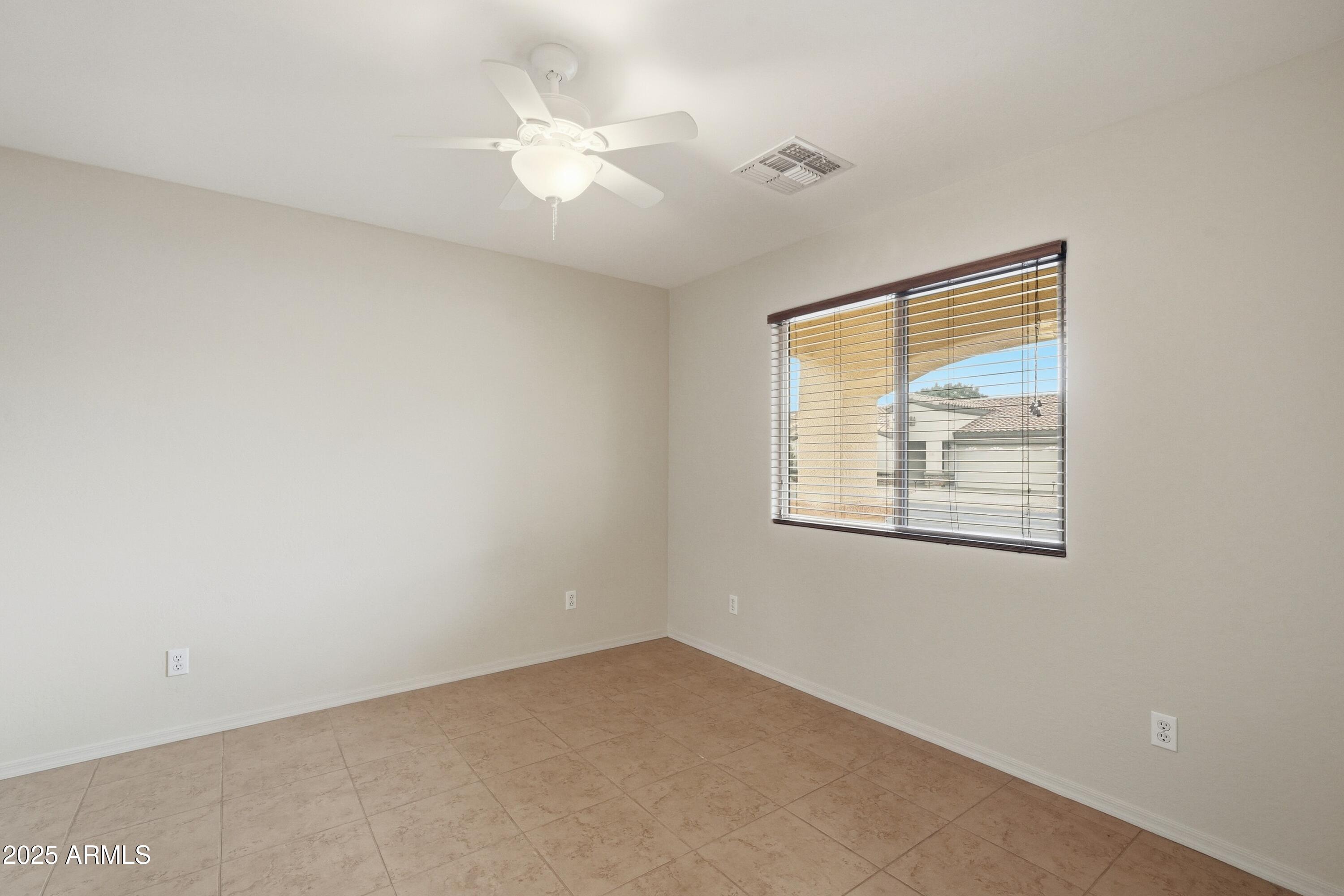 2101 South Meridian Road, Unit 210 Apache Junction, AZ 85120 - Photo 16 of 32 an empty room with windows and fan