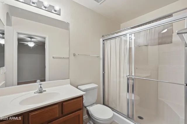 a bathroom with a sink a toilet a mirror and shower