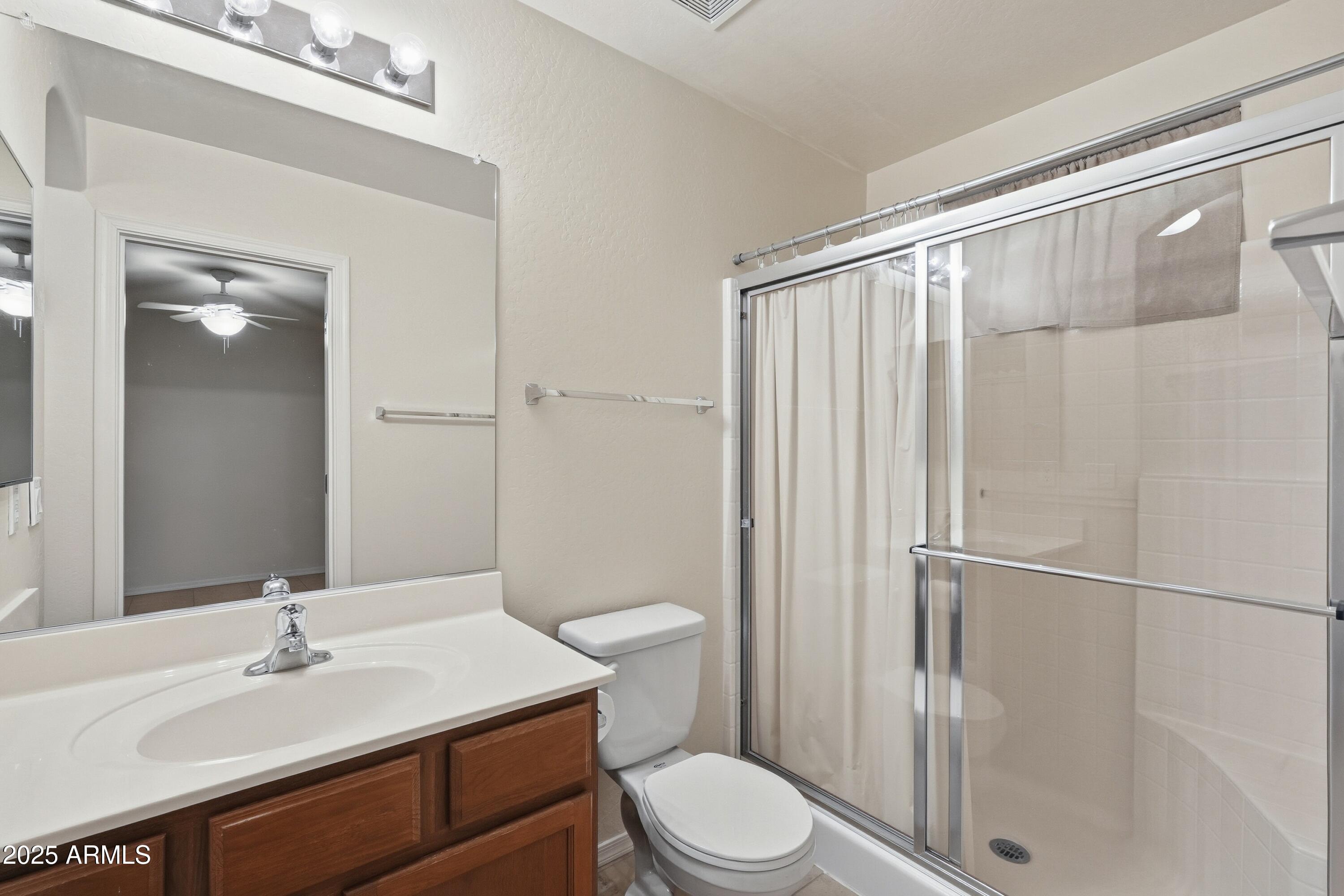 2101 South Meridian Road, Unit 210 Apache Junction, AZ 85120 - Photo 24 of 32 a bathroom with a sink a toilet a mirror and shower