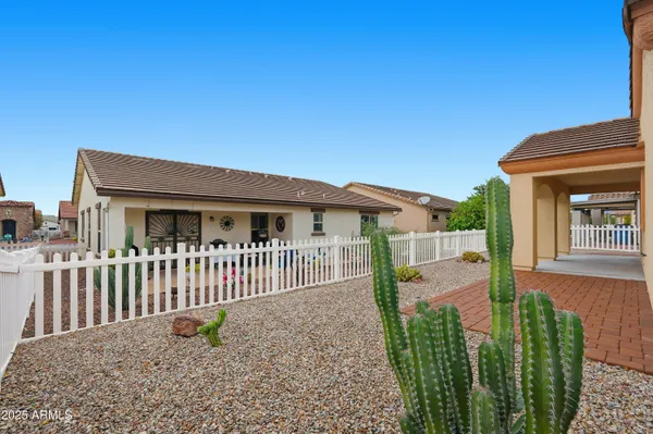 a view of a house with a small yard and plants
