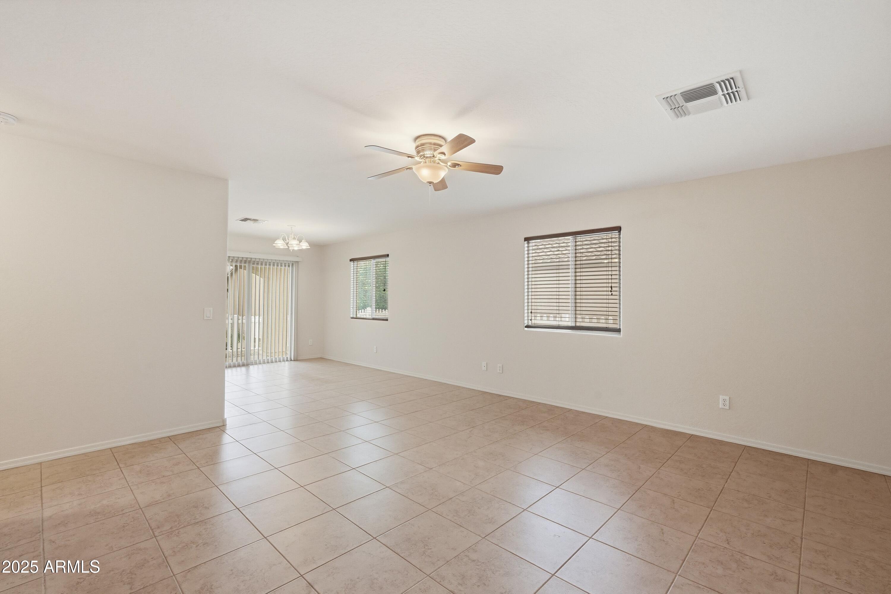 2101 South Meridian Road, Unit 210 Apache Junction, AZ 85120 - Photo 6 of 32 a view of an empty room with a ceiling fan and a window